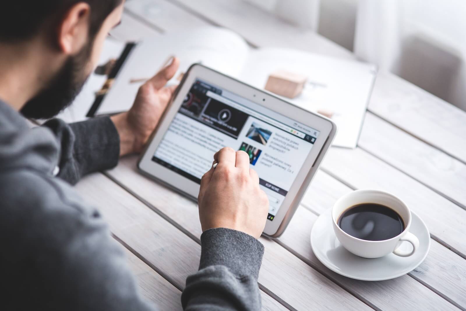 Man reading news on digital tablet