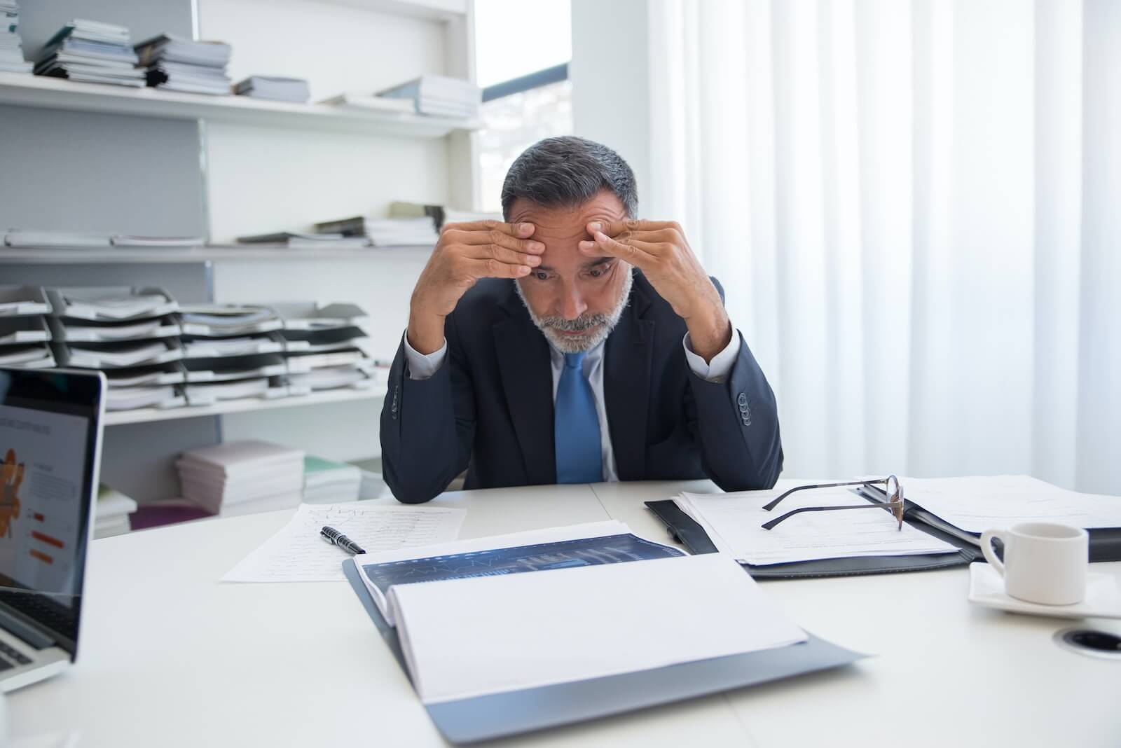 stressed man at his job in black suit