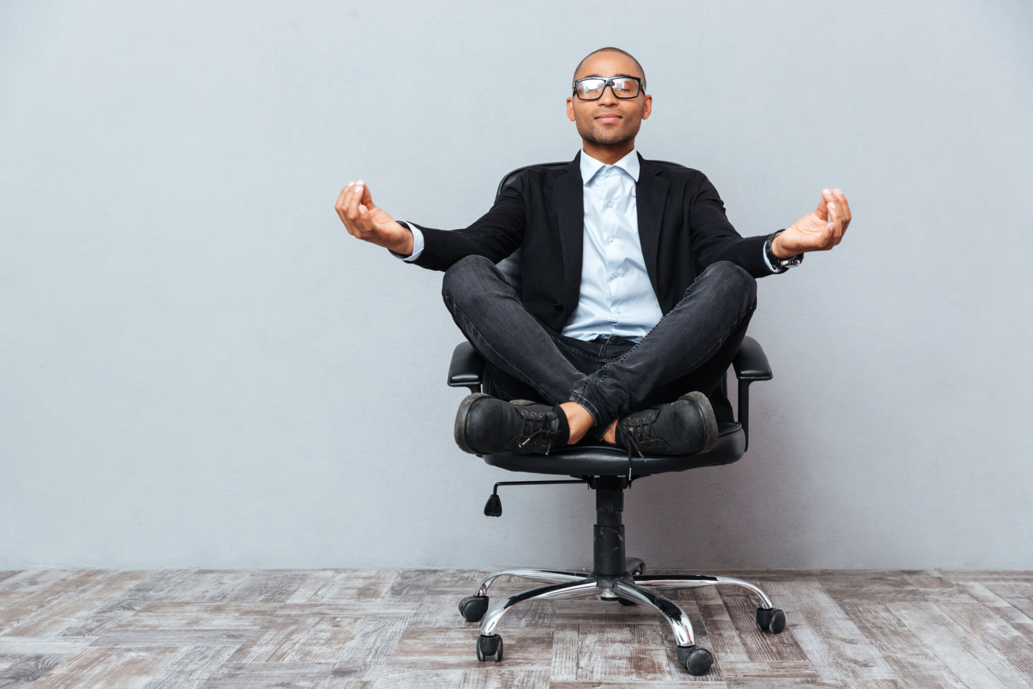 Man meditating or doing yoga at work