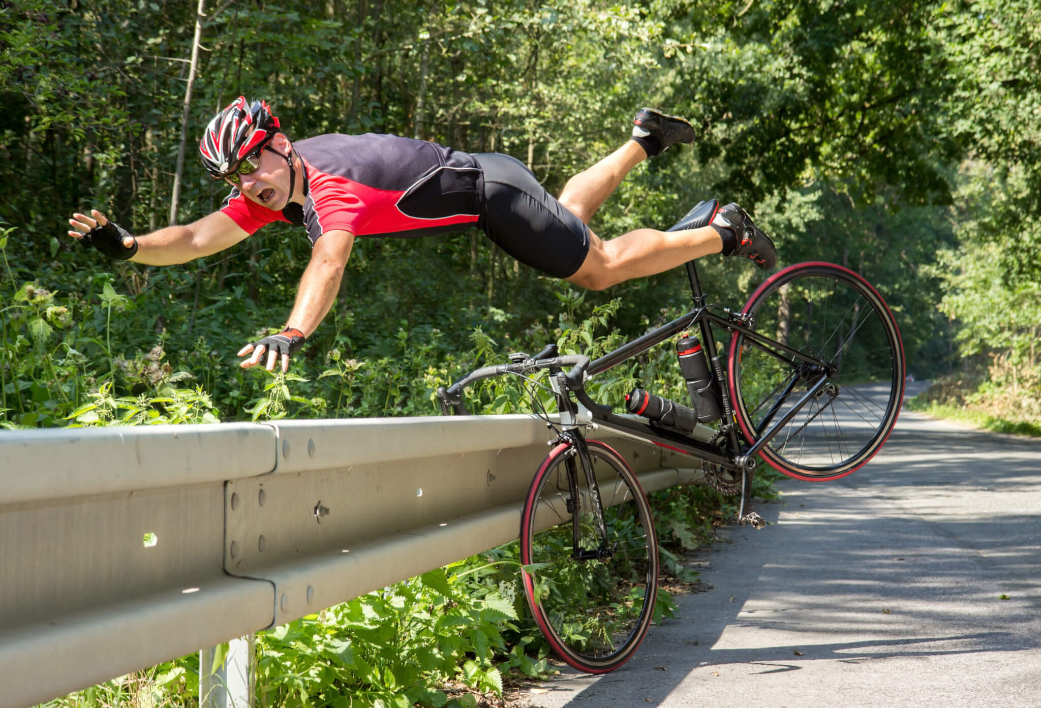 Bicyclist falls off the bike into bushes