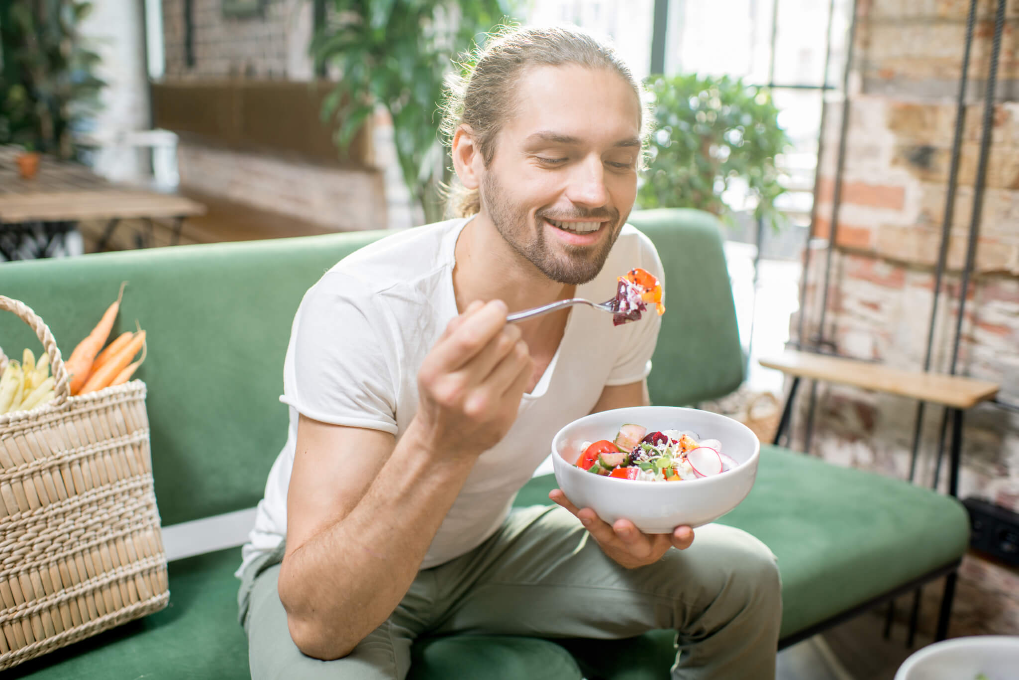 Man eating salad, enjoying healthy diet