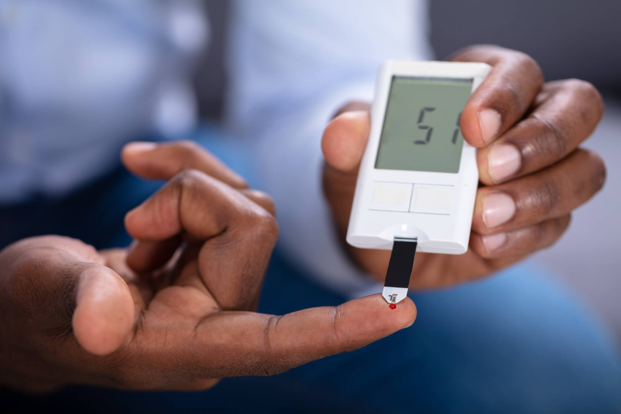 Man With Diabetes Checking Blood Sugar Level With Glucometer