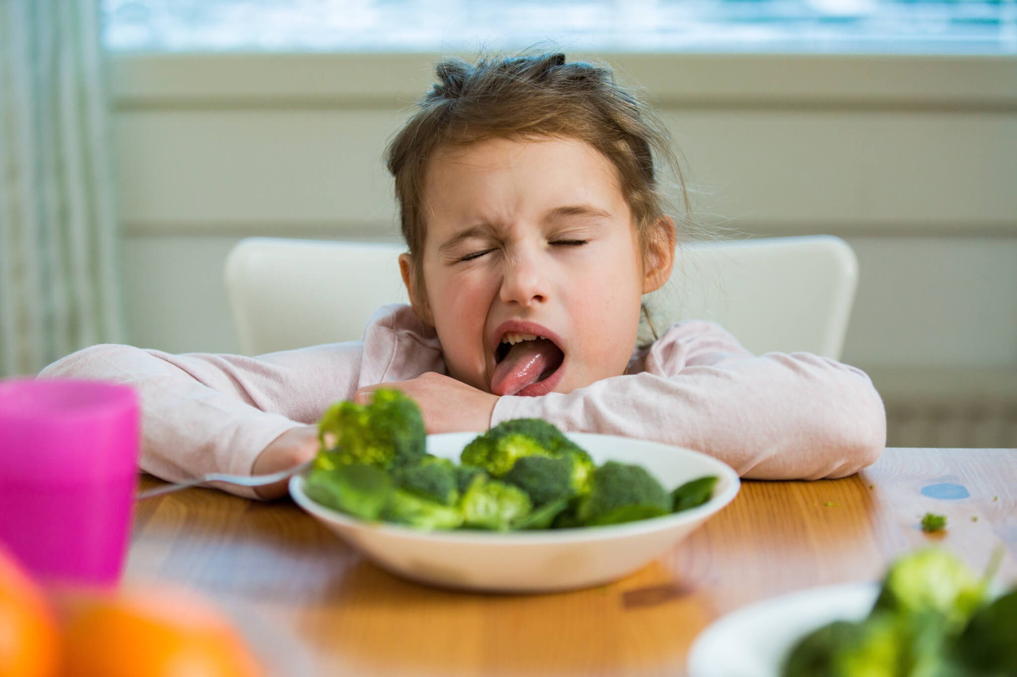 Little girl hates vegetables, broccoli