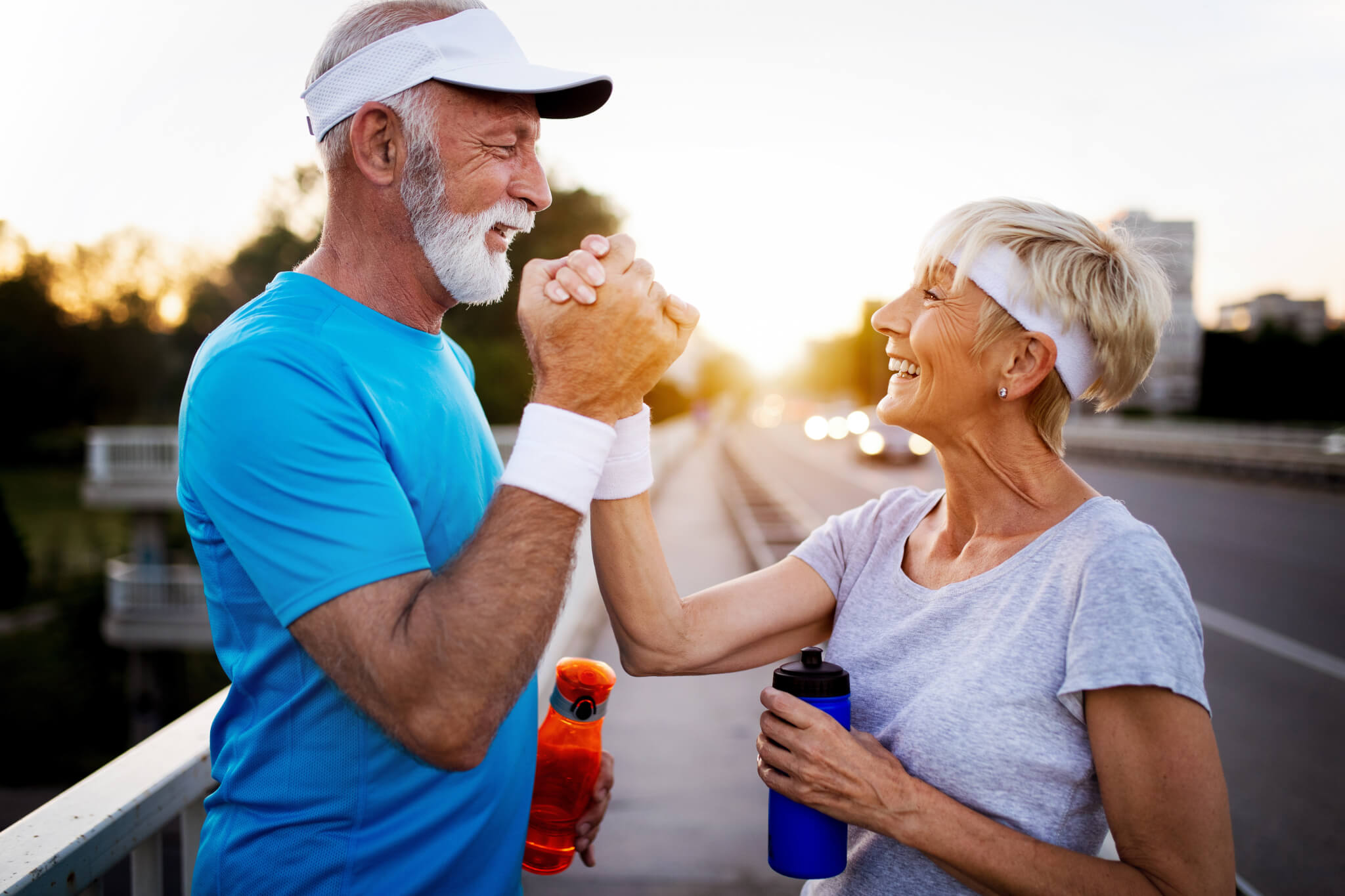 Happy older senior couple exercising or working out