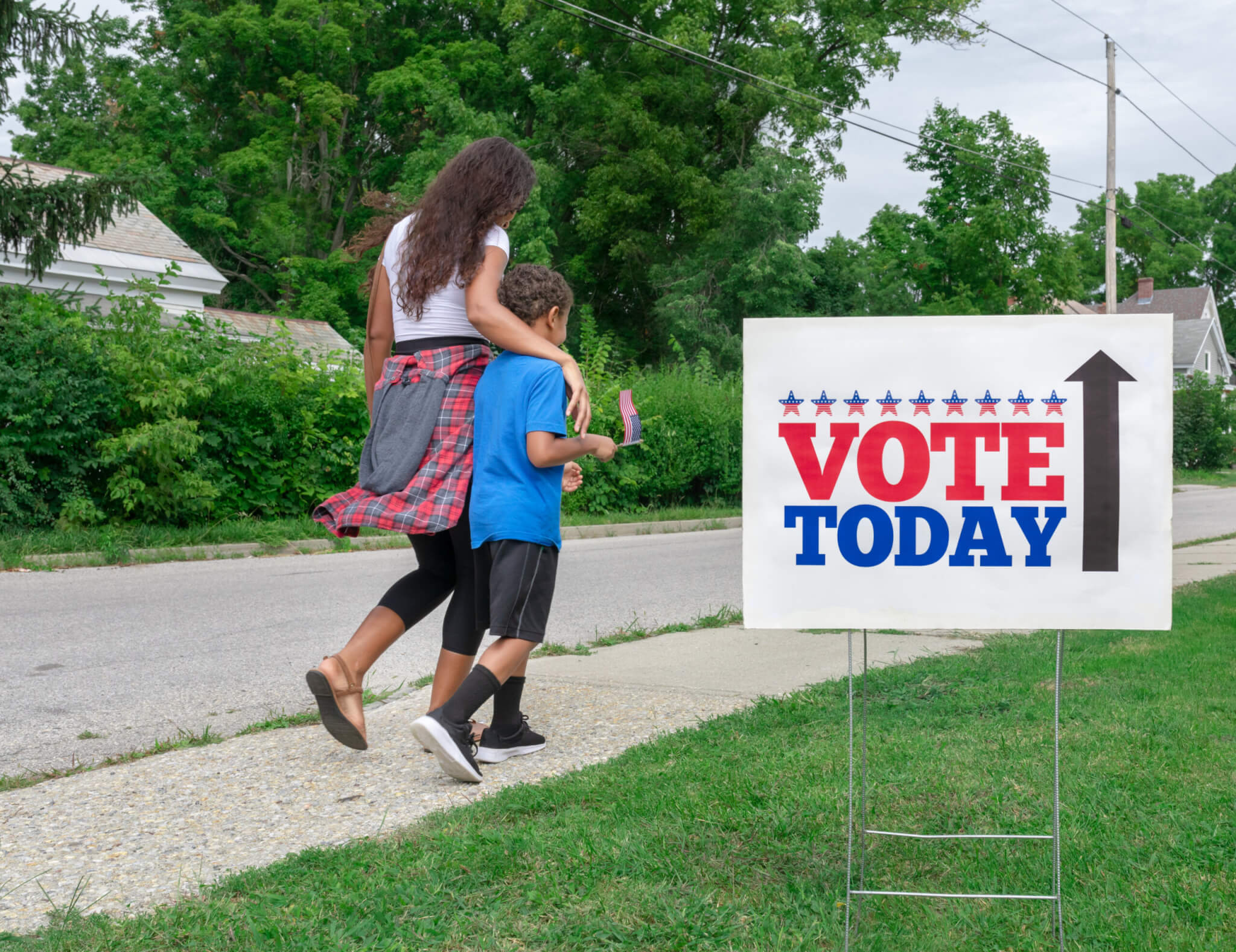 Mother walking to vote with child