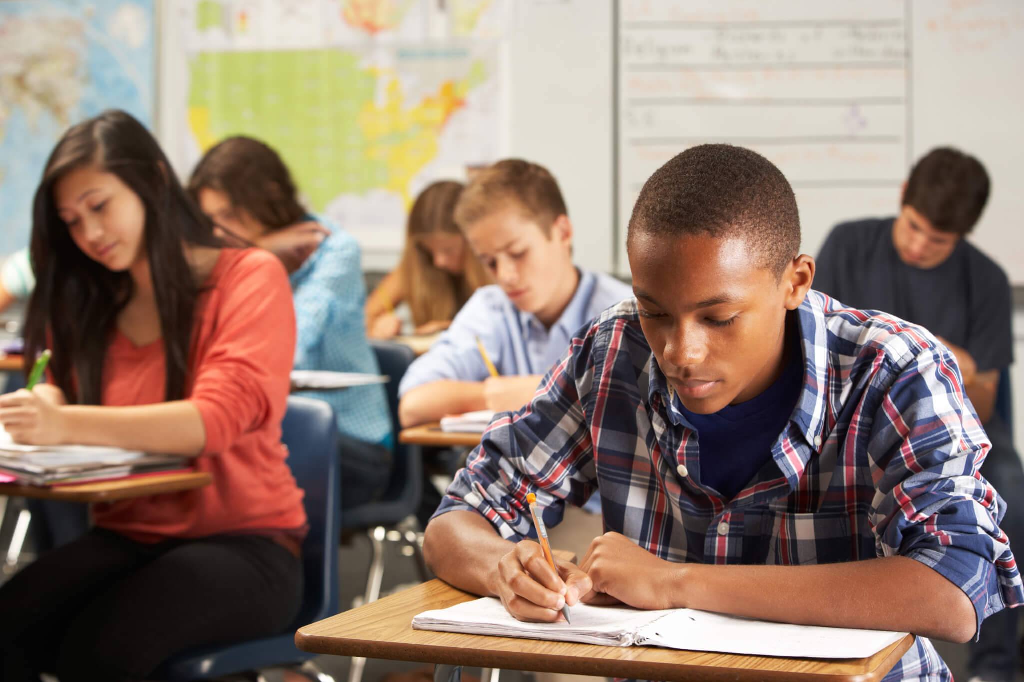 High school student studying, taking exam in class