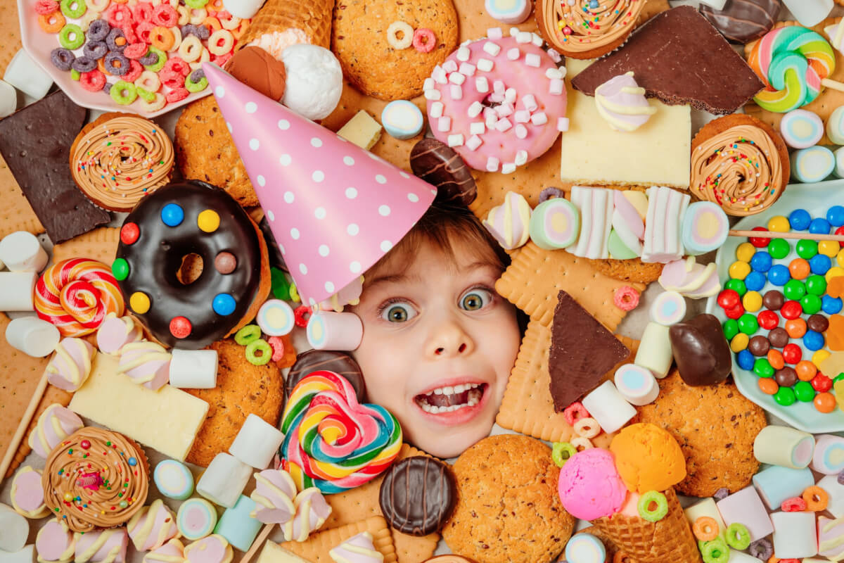 child in a collection of candy