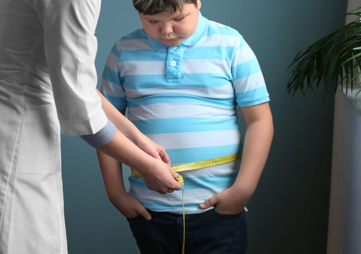 Doctor measuring overweight boy