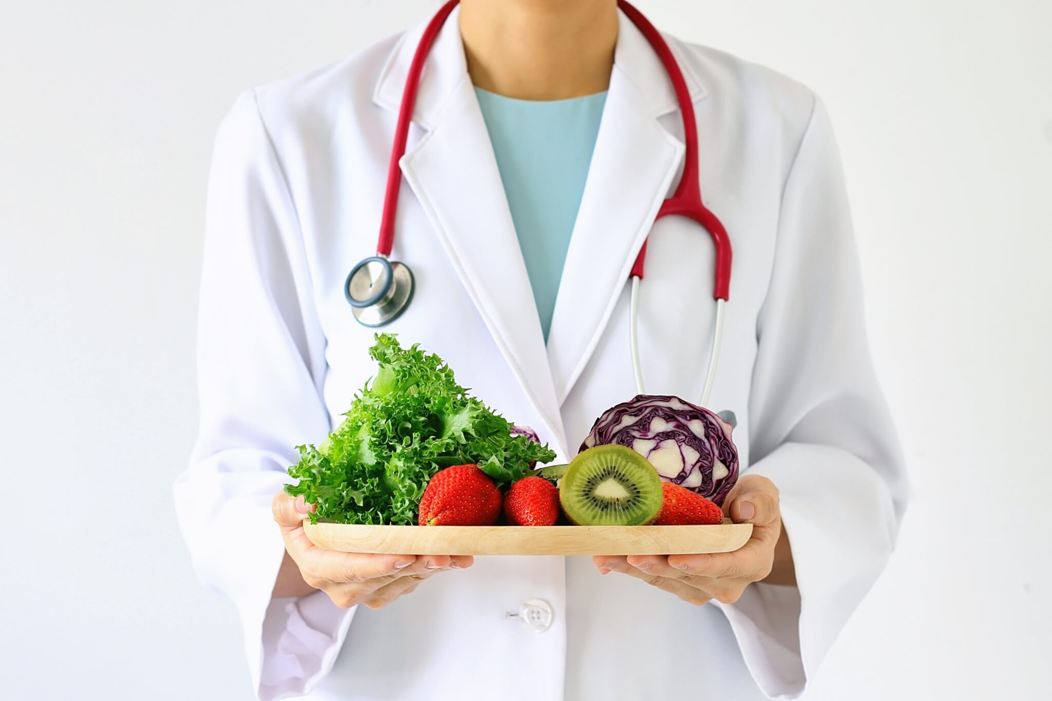 Doctor holding fresh fruit and vegetable tray