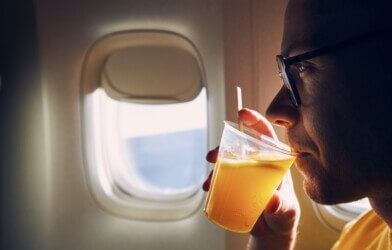 Passenger drinking alcohol during airplane flight