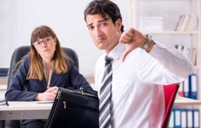 employee giving thumbs down in office