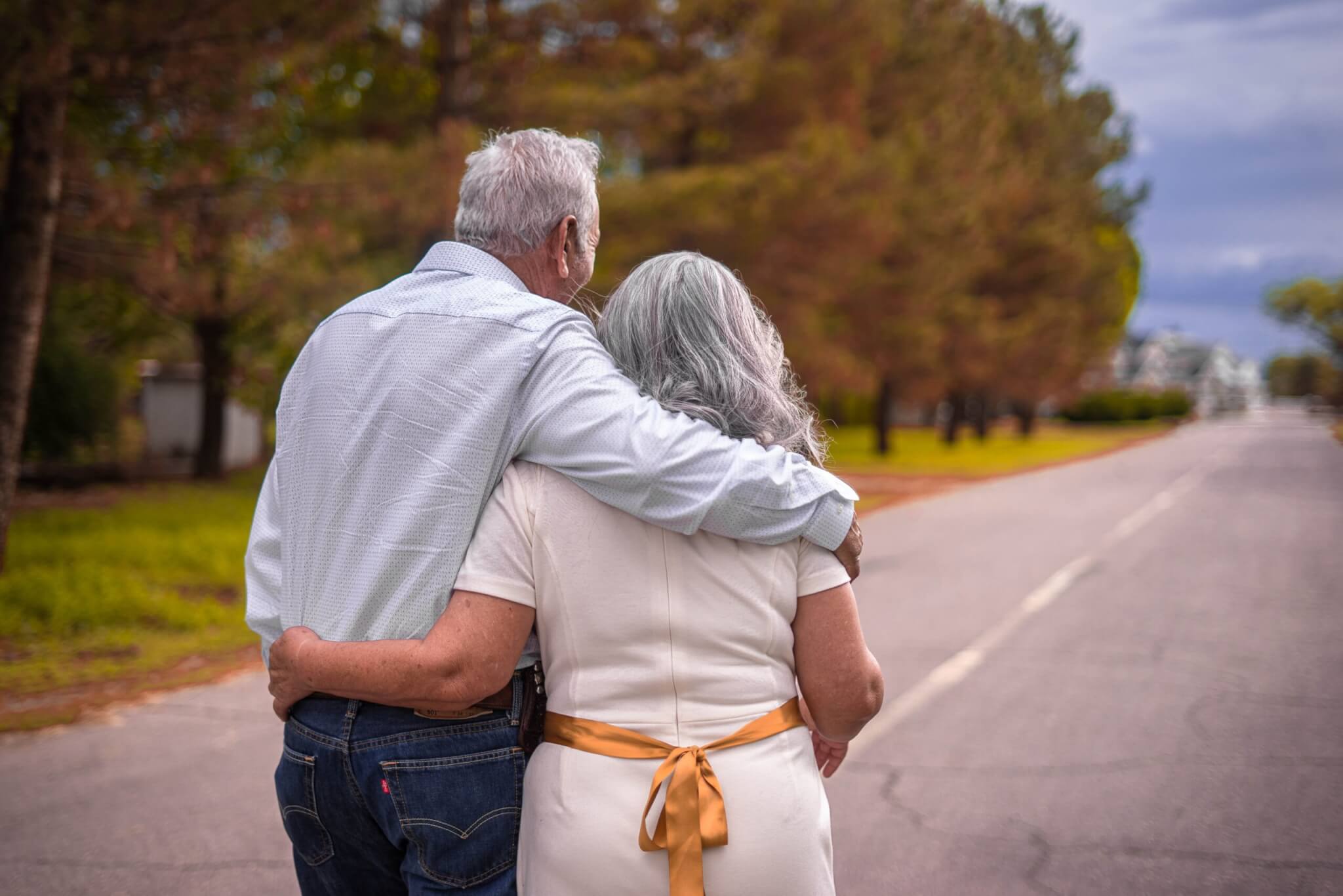 Older couple walking down street.