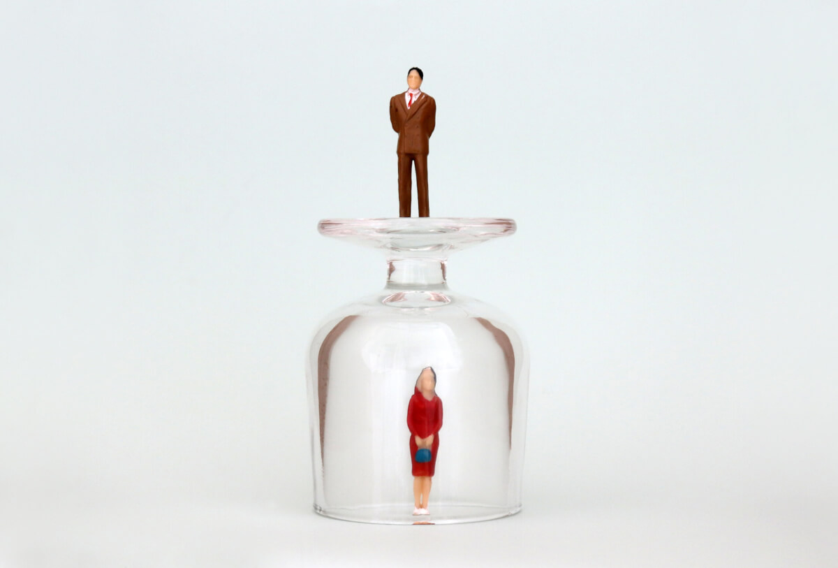 Woman stuck under glass ceiling with man on top