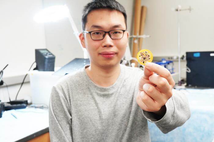 Jiuyun Shi holds a small device he and a team of University of Chicago scientists invented that integrates living cells, gel, and sensors to create “living bioelectronics” to heal skin. 