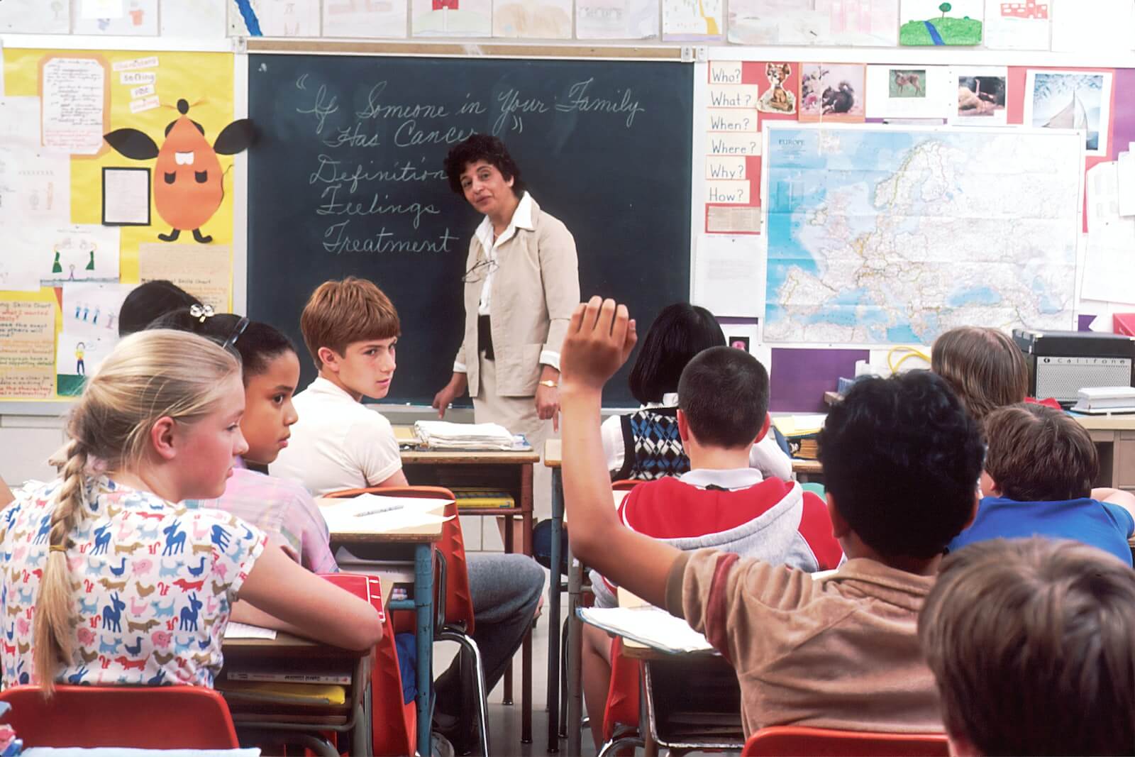 a student raising their hand in class