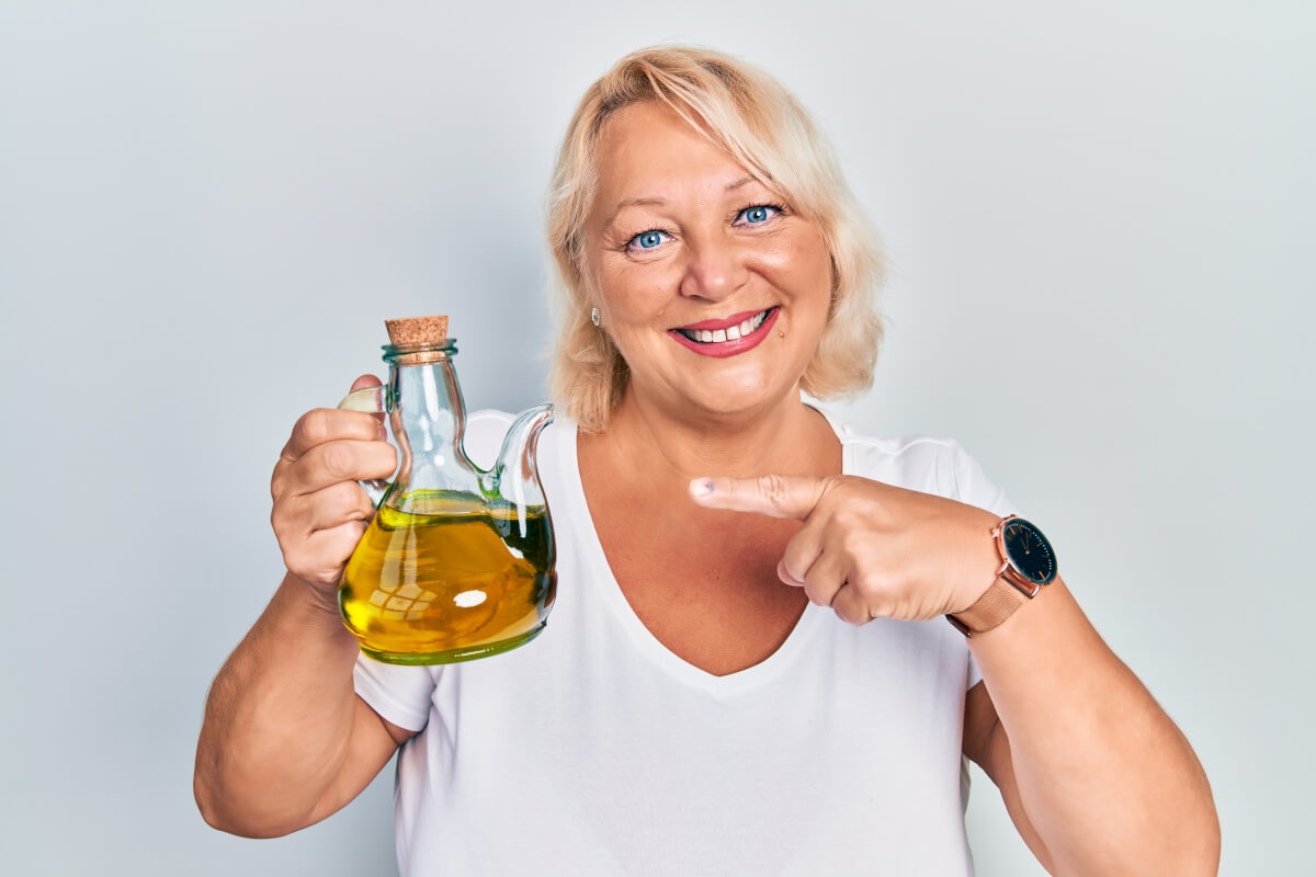 Woman holding an olive oil carafe