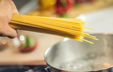 Person Holding Raw Pasta