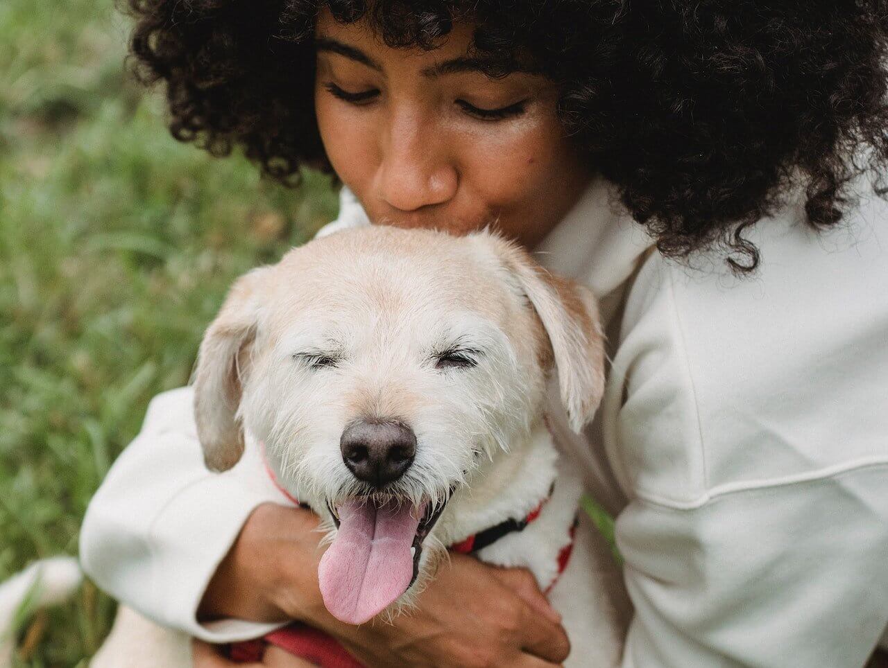 Woman kissing her dog