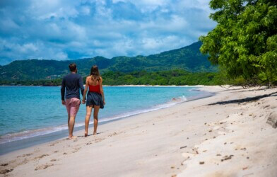 A couple walking on a beach in Costa Rica