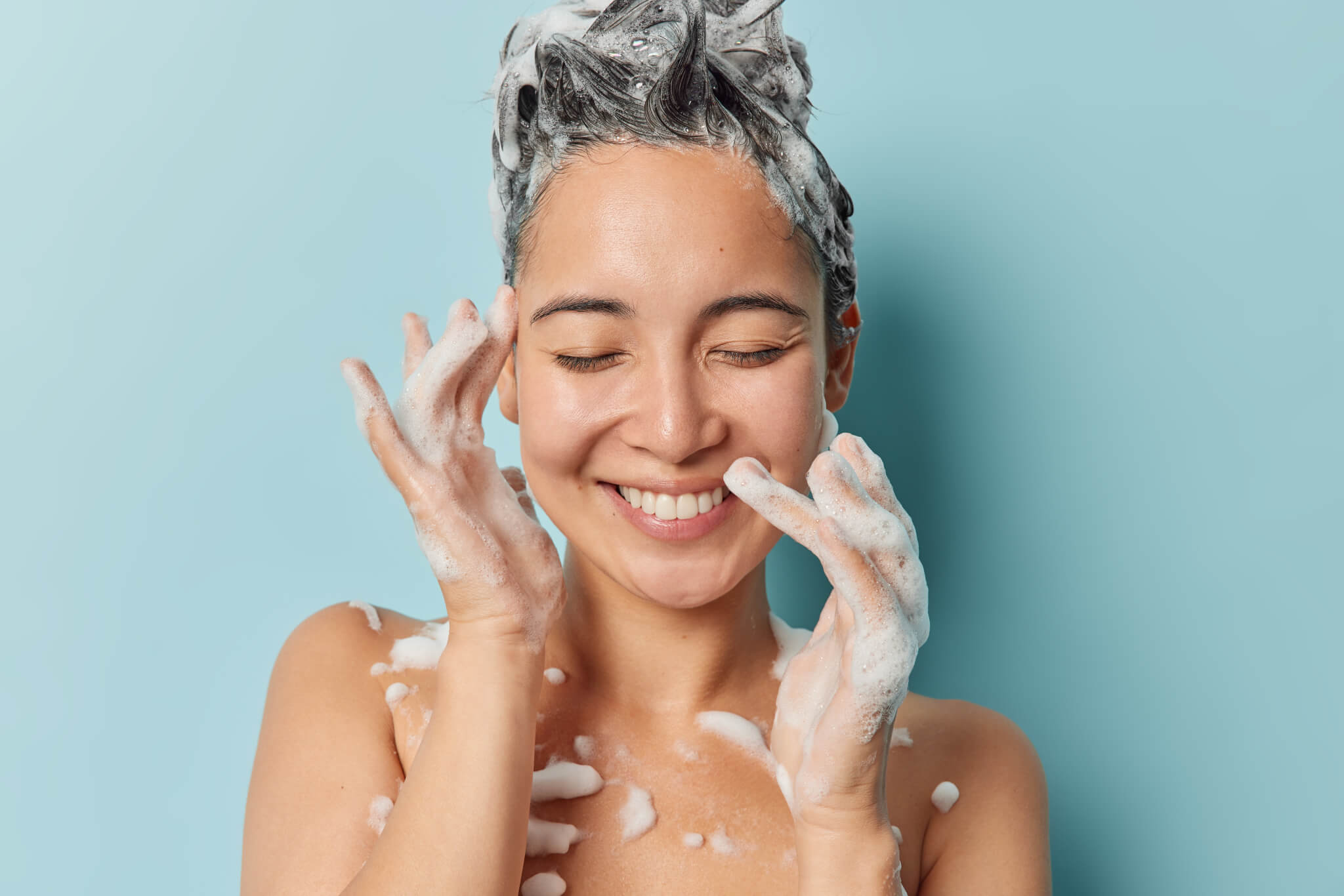 A woman shampooing her hair